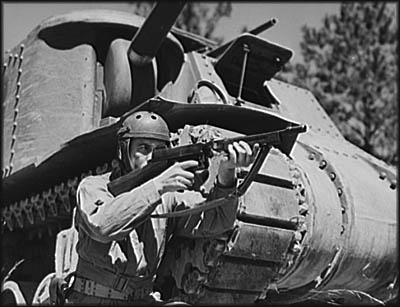 Soldier showing how the Thompson submachine gun could complement U.S. armor. Photo by Alfred T. Palmer. United States. Office of War Information.