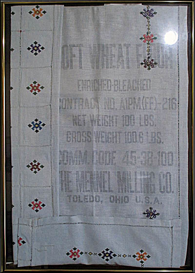 Ukrainian Museum-Archives This former flour sack was embroidered by Maria Kowalysko, was repurposed as a table cloth. Kowalkysko was a displaced person who fled from the returning Soviet forces and wound up in a camp in Germany.